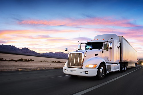 Truck and highway at sunset – transportation background